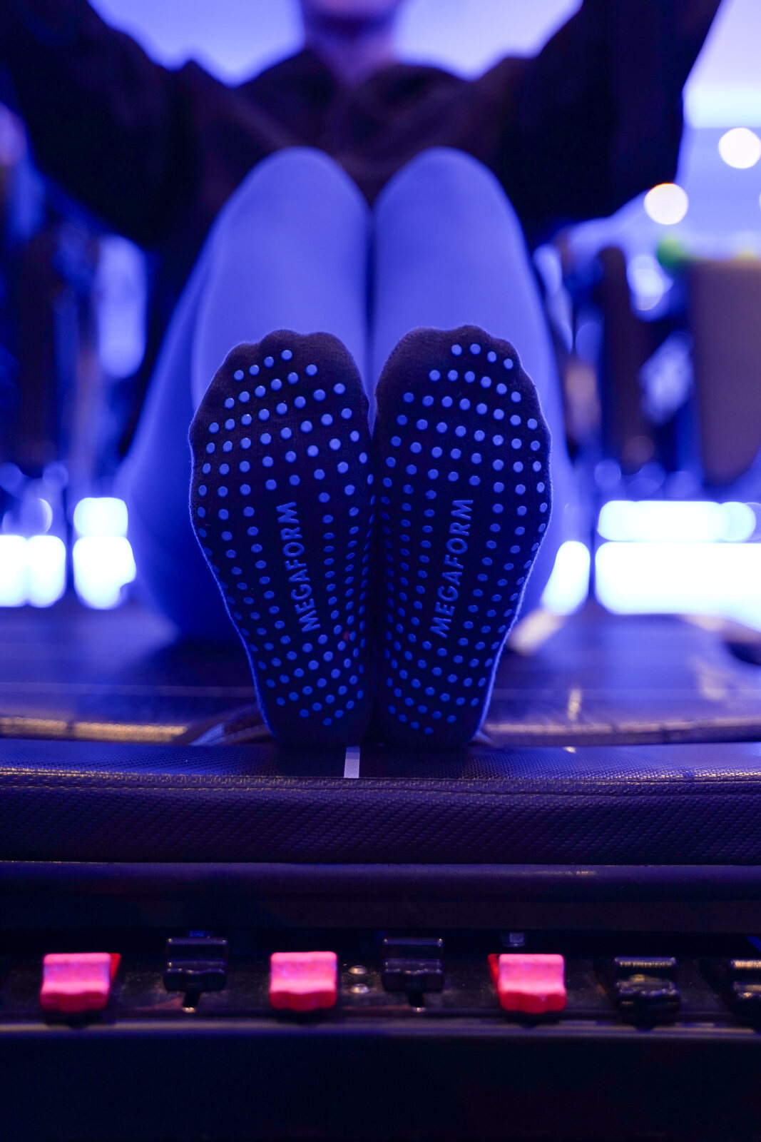 Megaform grip socks on a Megaformer in the blue-lit Eugene studio